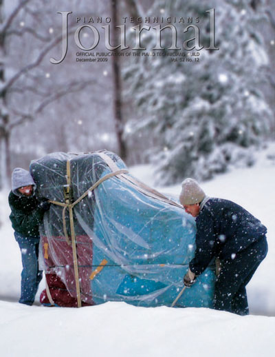 Louis Gentile and assistant moving a piano in the snow