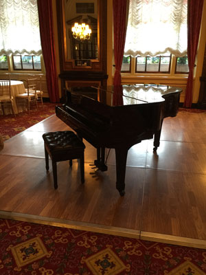 One of our rental grand pianos in a hotel ballroom